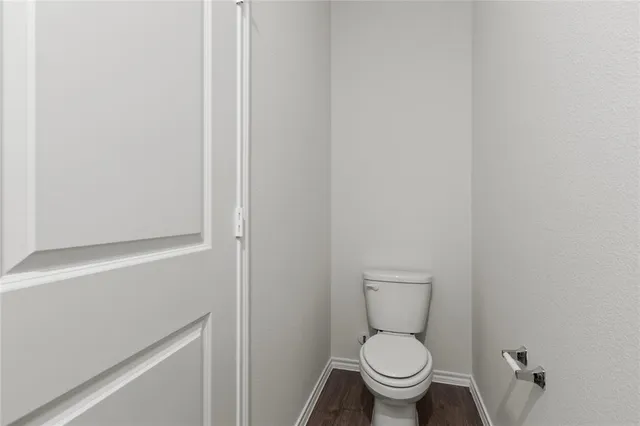 a white toilet sitting next to a shower