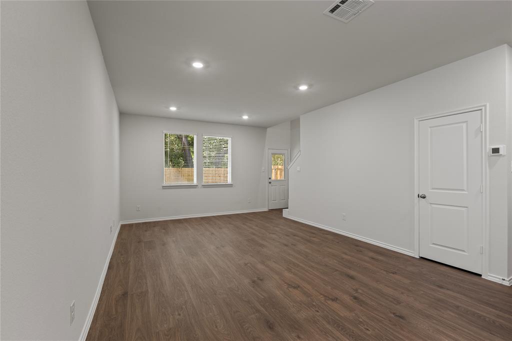 7016 Vining Drive Princeton, TX 75407 - Photo 8 of 22 a view of an empty room with wooden floor and a window
