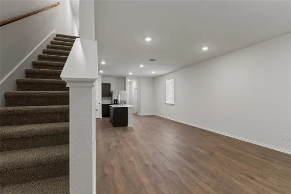 a view of kitchen and hall with wooden floor