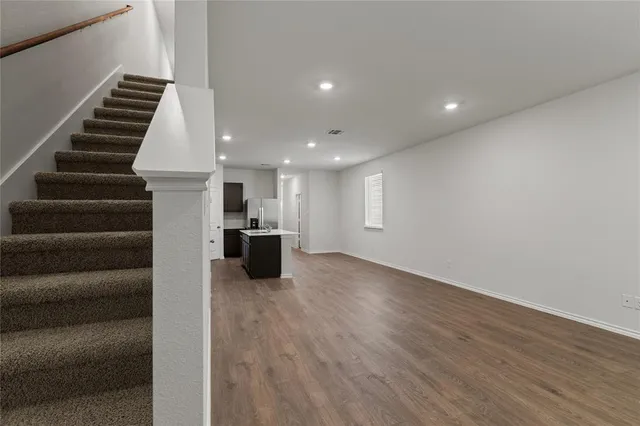 a view of kitchen and hall with wooden floor
