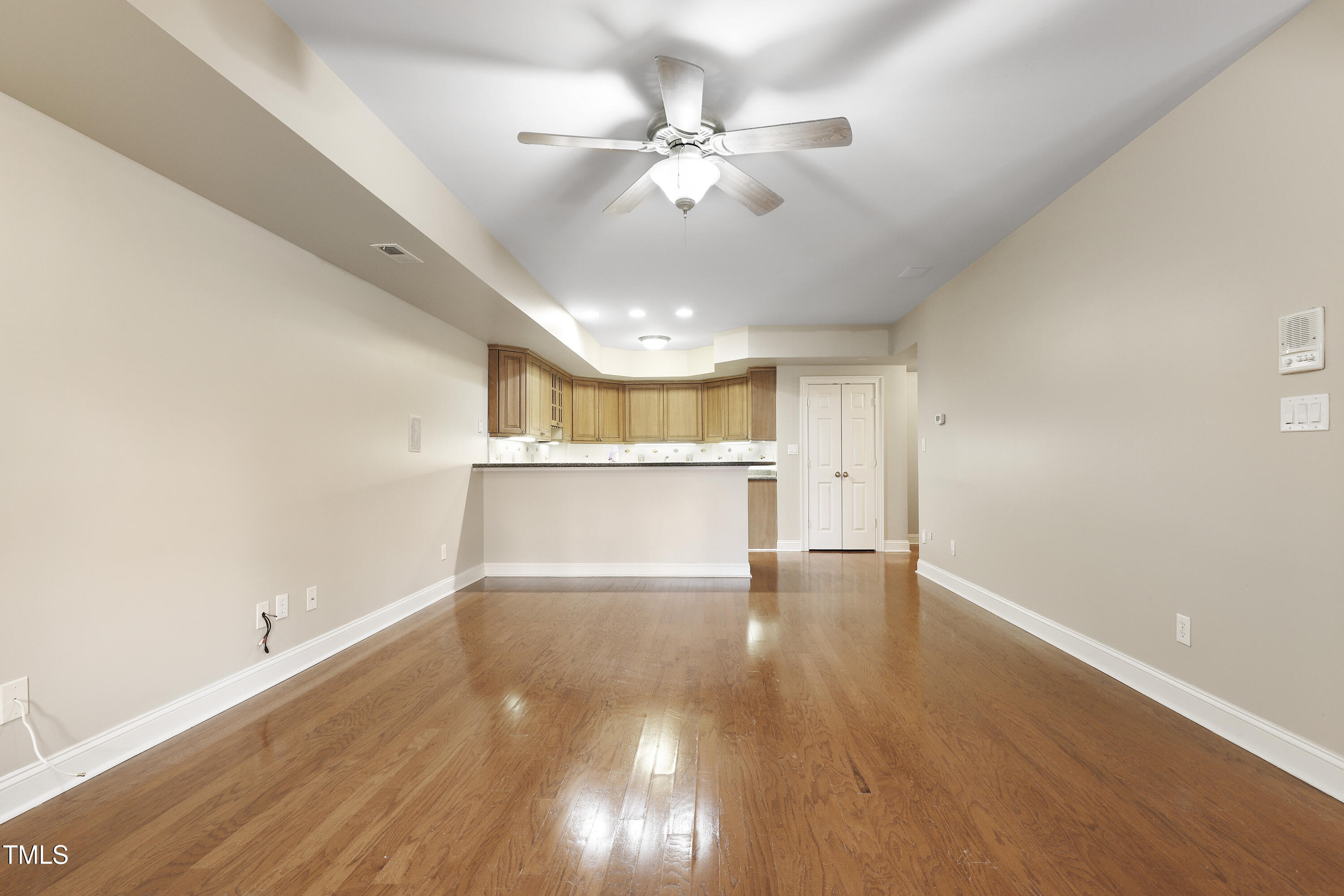 12309 Beestone Lane Raleigh, NC 27614 - Photo 54 of 73 a view of an empty room with wooden floor and a ceiling fan