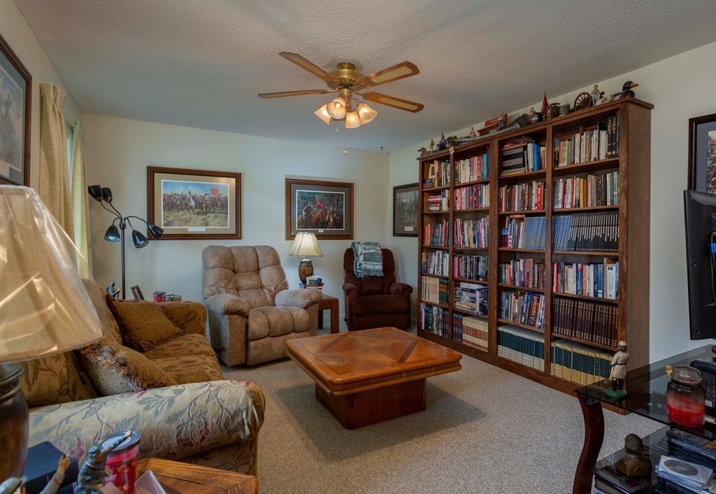 9068 Rhea County Highway Dayton, TN 37321 - Photo 11 of 34 a living room with furniture and a book shelf