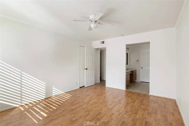 a view of a livingroom with a ceiling fan and window