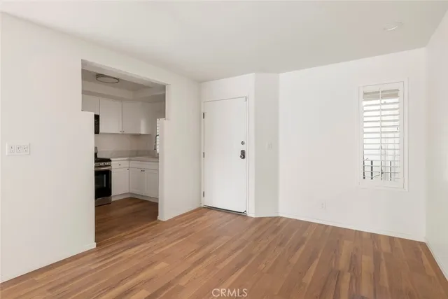 a view of a kitchen with wooden floor and a sink