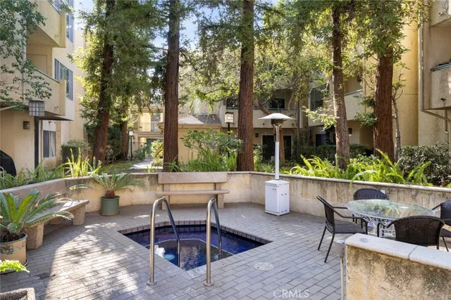 a patio filled with furniture and potted plants