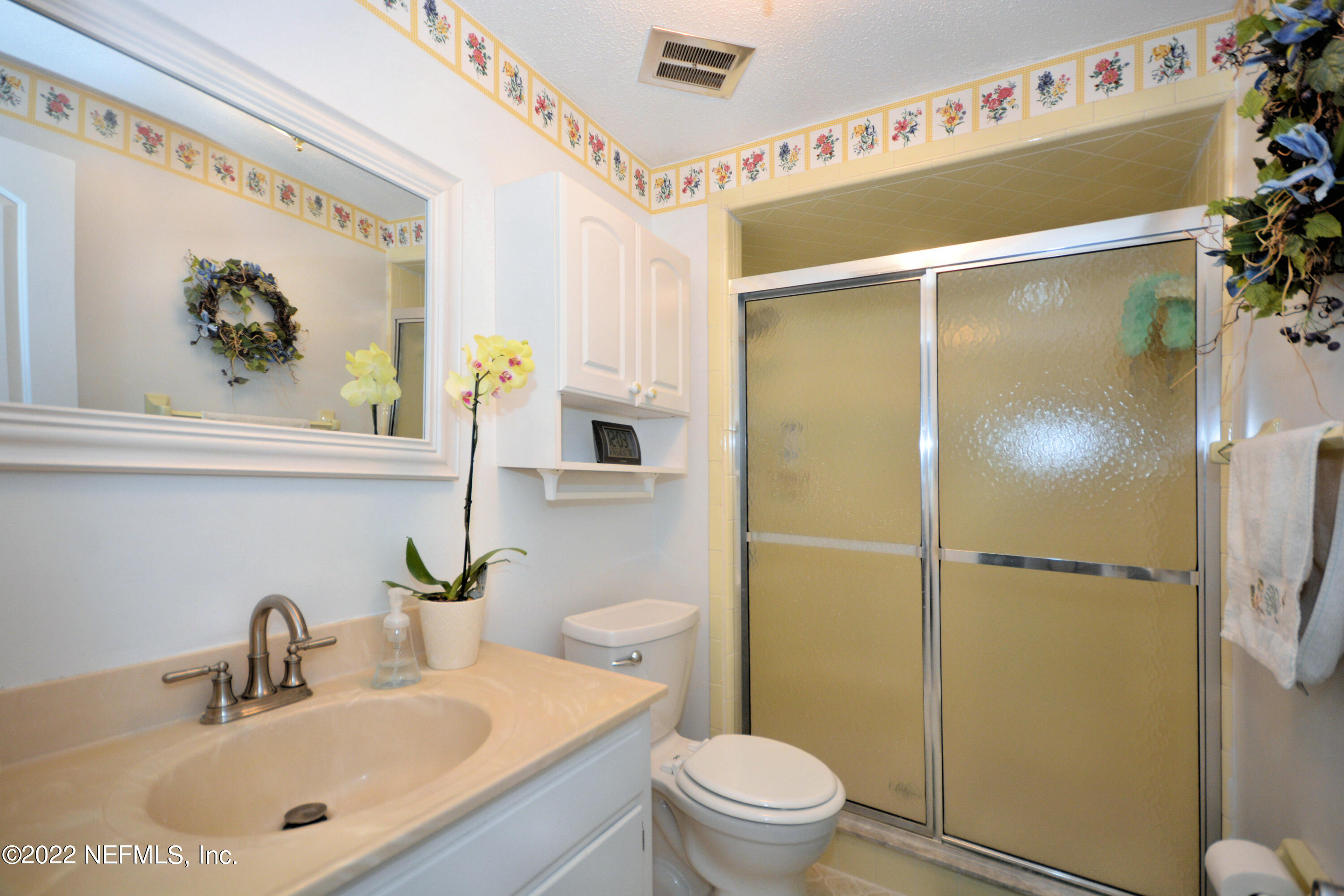 2282 Marcel Drive Orange Park, FL 32073 - Photo 17 of 29 a bathroom with a sink mirror toilet and shower