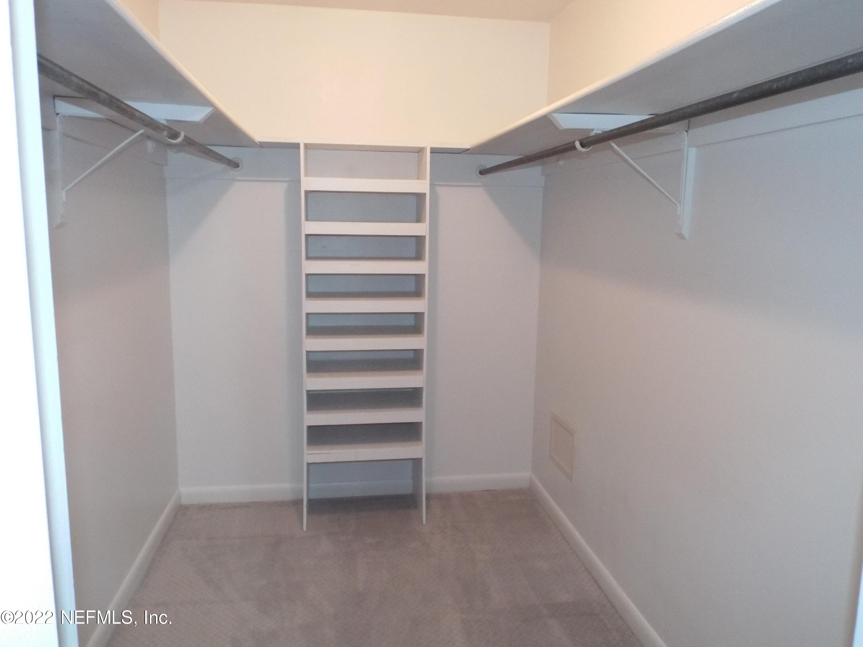 2282 Marcel Drive Orange Park, FL 32073 - Photo 18 of 29 a view of walk in closet with empty racks