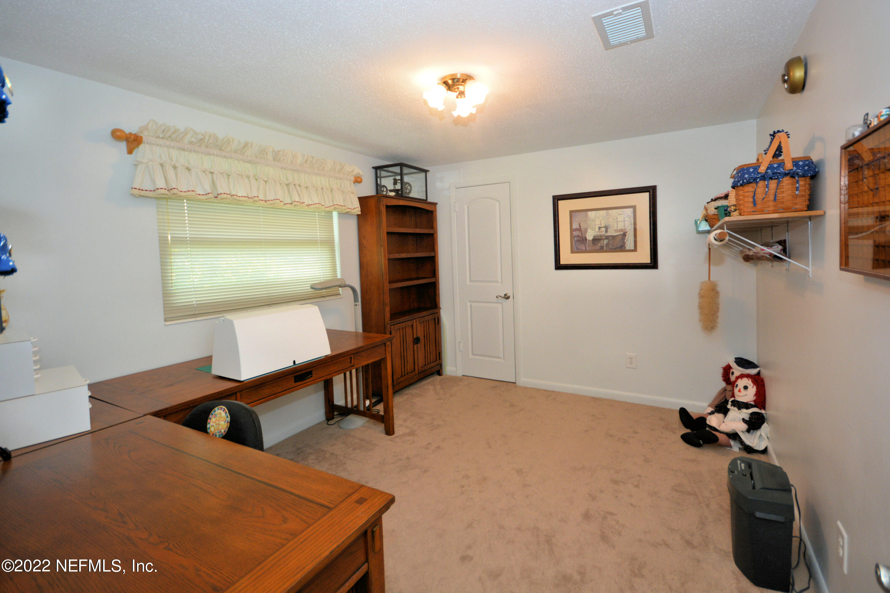 2282 Marcel Drive Orange Park, FL 32073 - Photo 20 of 29 a bedroom with furniture and a window