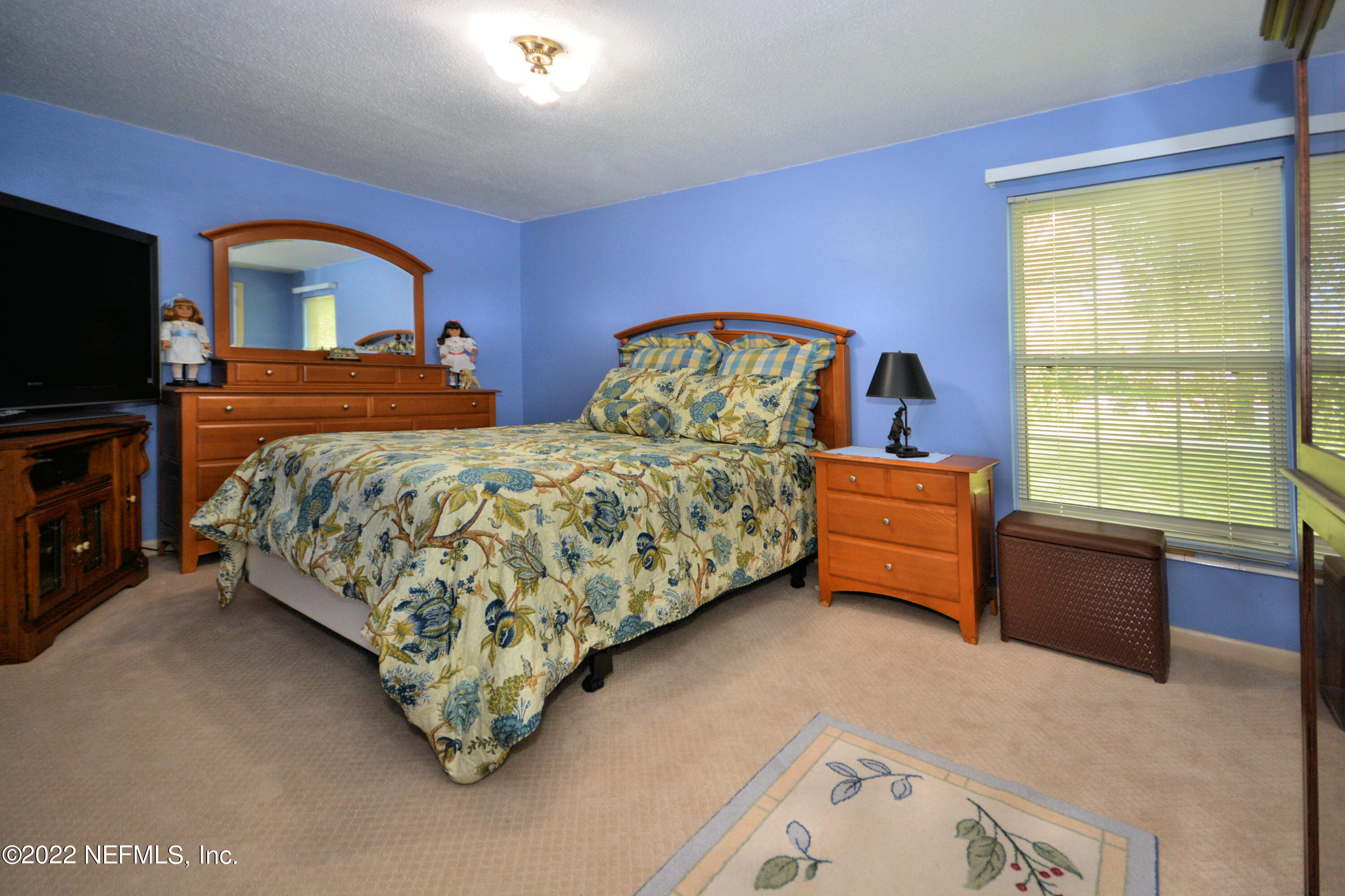 2282 Marcel Drive Orange Park, FL 32073 - Photo 22 of 29 a bedroom with a bed and a view of en suite bathroom