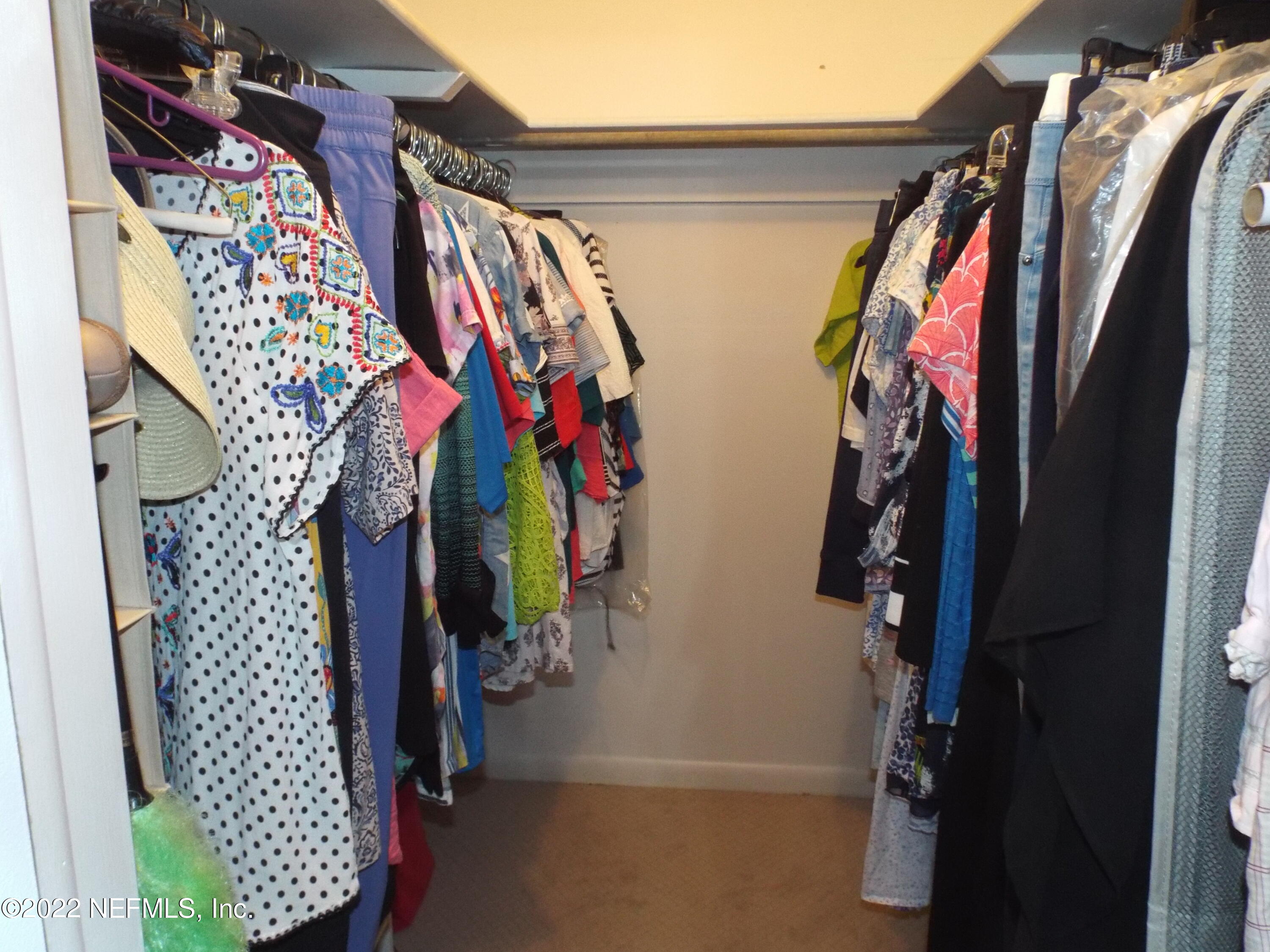 2282 Marcel Drive Orange Park, FL 32073 - Photo 23 of 29 a view of walk in closet with clothes and shoes