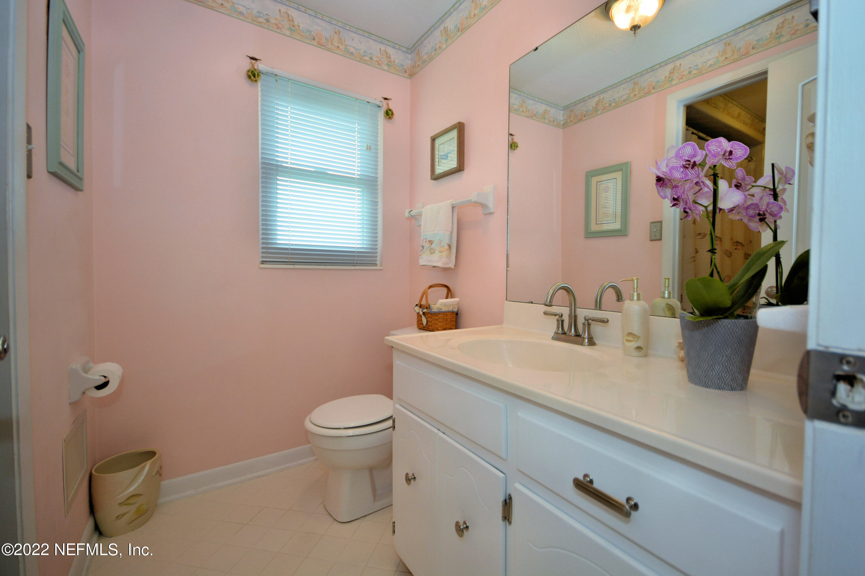 2282 Marcel Drive Orange Park, FL 32073 - Photo 24 of 29 a bathroom with a toilet sink and mirror