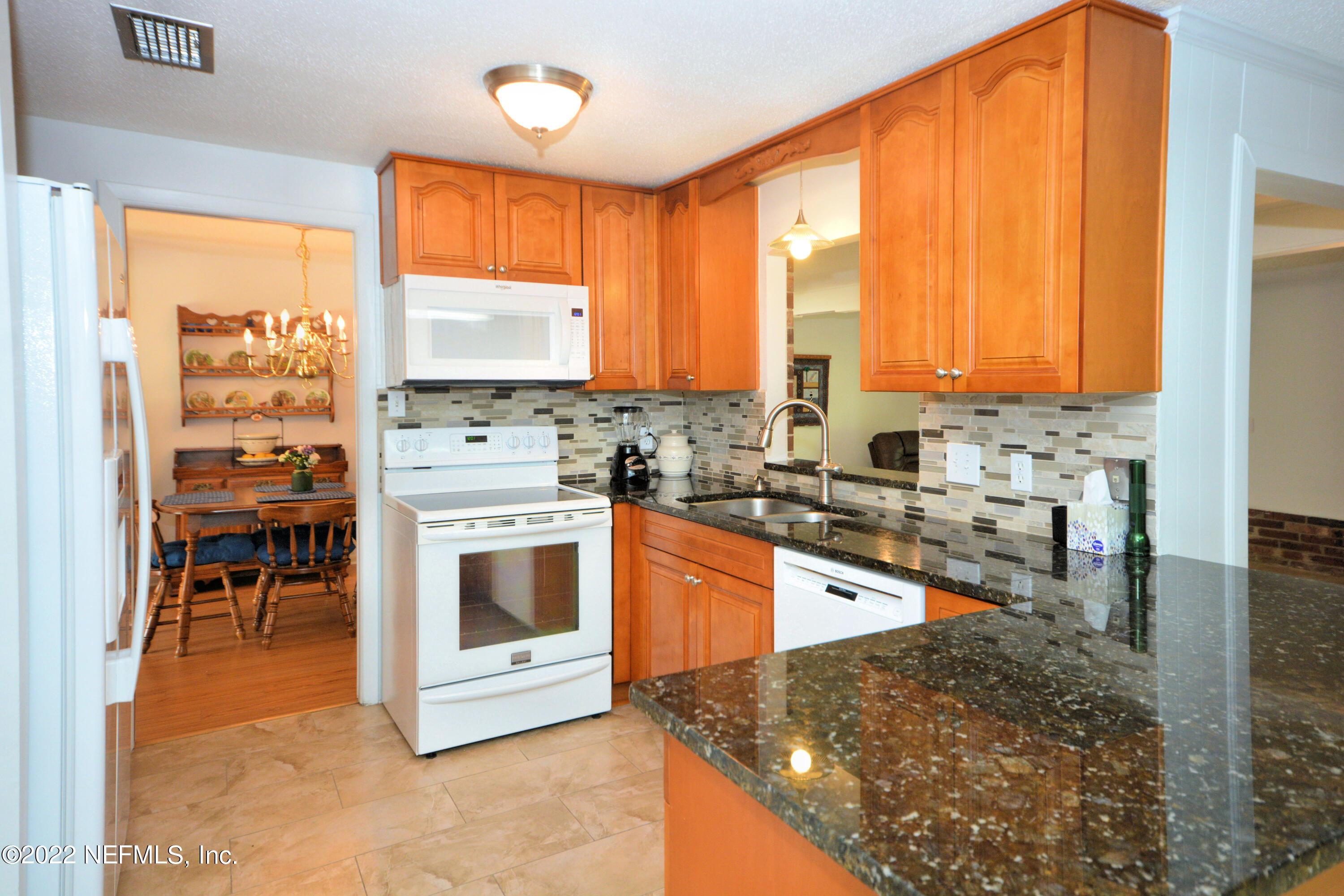 2282 Marcel Drive Orange Park, FL 32073 - Photo 9 of 29 a kitchen with stainless steel appliances granite countertop a stove a sink and a microwave