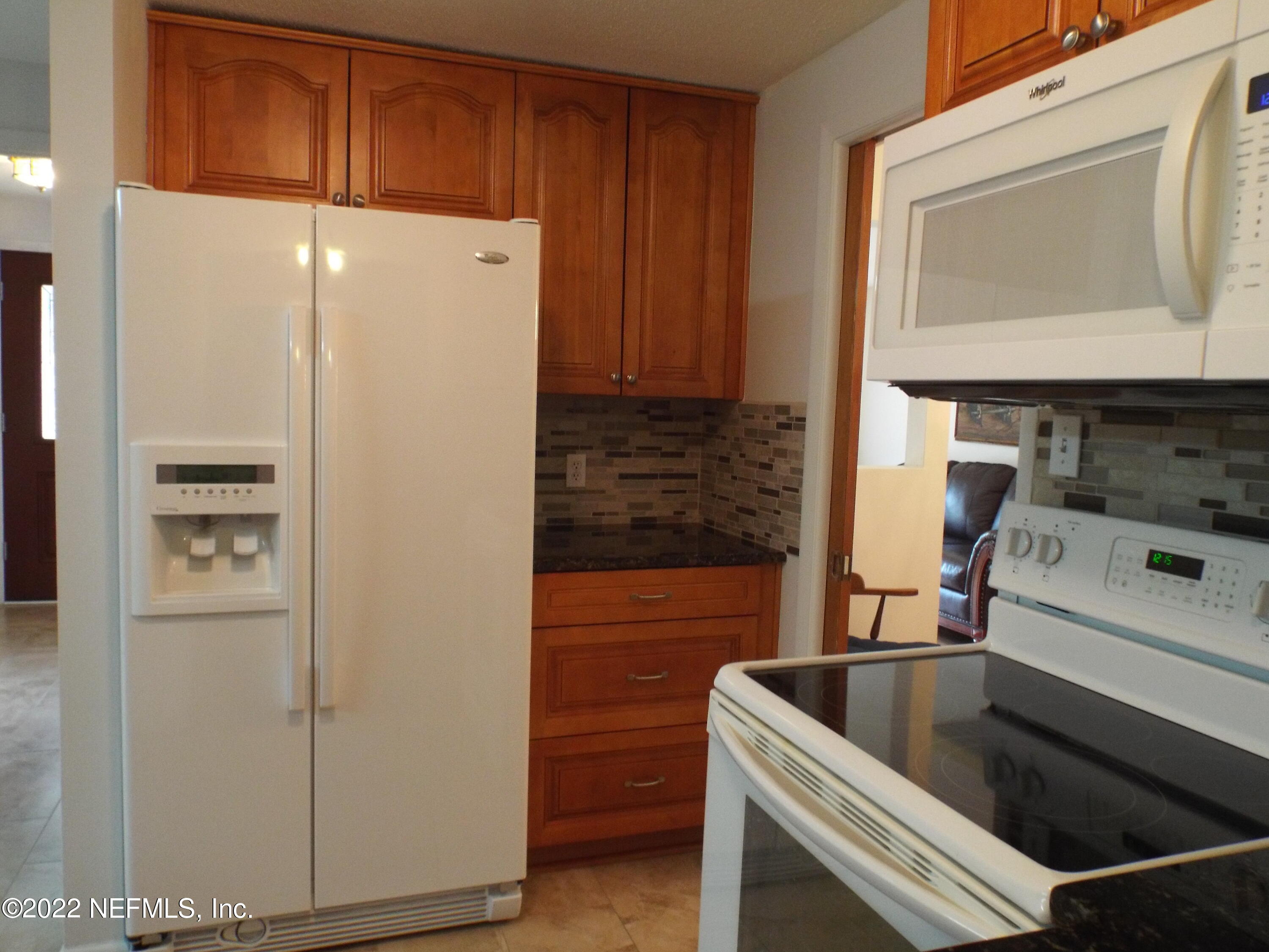 2282 Marcel Drive Orange Park, FL 32073 - Photo 10 of 29 a kitchen with a refrigerator sink and cabinets