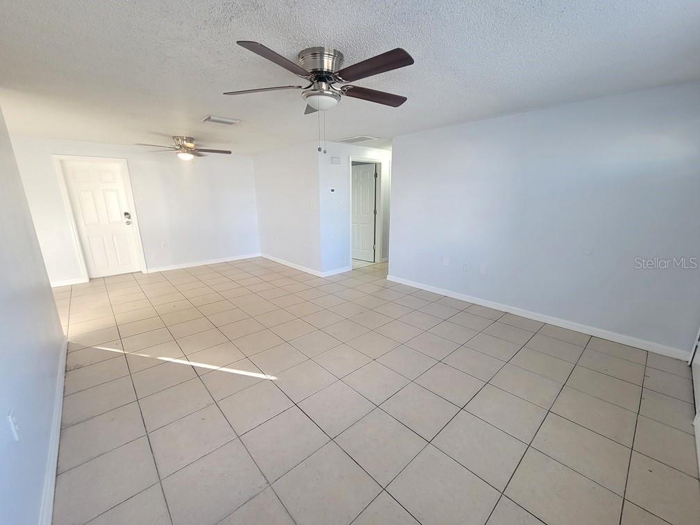 1415 Wickham Lane Holiday, FL 34691 - Photo 4 of 17 a view of a livingroom with a ceiling fan and wooden floor