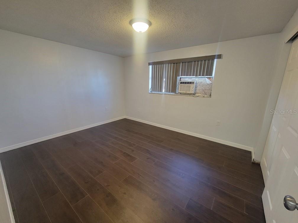 1415 Wickham Lane Holiday, FL 34691 - Photo 7 of 17 a view of a room with wooden floor and windows
