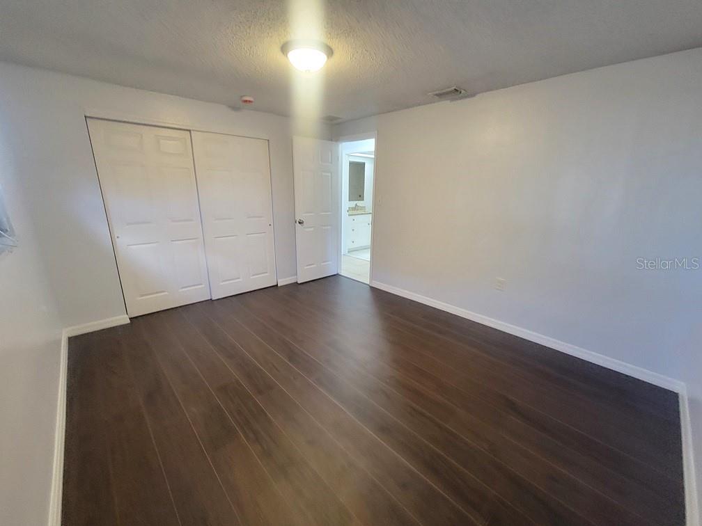 1415 Wickham Lane Holiday, FL 34691 - Photo 8 of 17 a view of an empty room with wooden floor