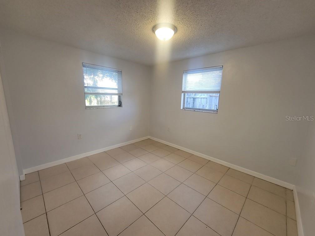 1415 Wickham Lane Holiday, FL 34691 - Photo 10 of 17 an empty room with windows