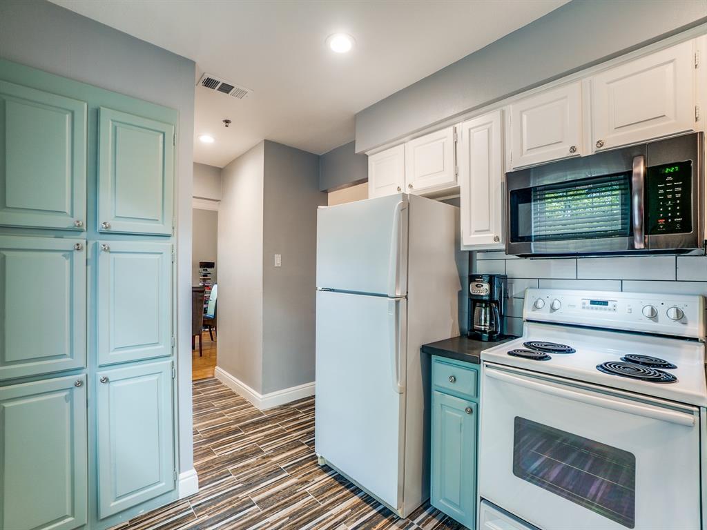 5407 Bryan Street, Unit B209 Dallas, TX 75206 - Photo 14 of 25 a kitchen with stainless steel appliances a refrigerator stove and microwave