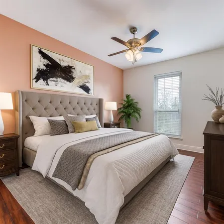 a bedroom with a large bed and a window