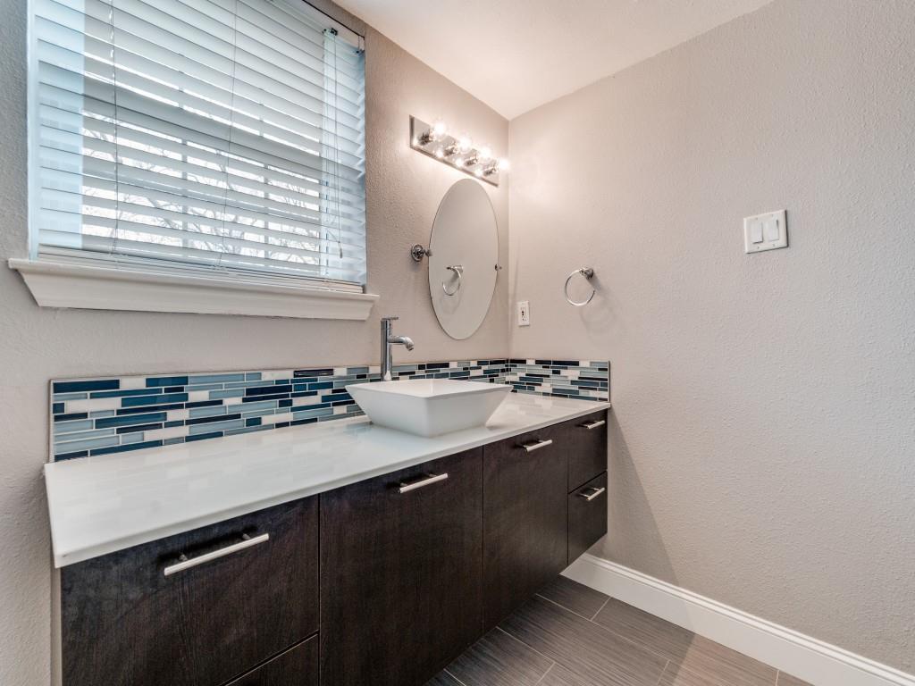 5407 Bryan Street, Unit B209 Dallas, TX 75206 - Photo 18 of 25 a bathroom with a sink and a mirror