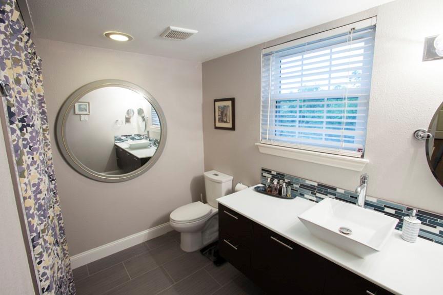 5407 Bryan Street, Unit B209 Dallas, TX 75206 - Photo 19 of 25 a bathroom with a sink and a mirror