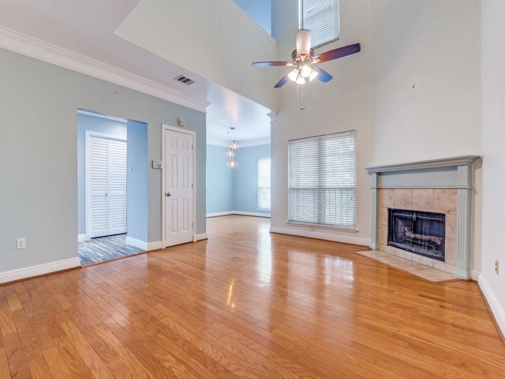 5407 Bryan Street, Unit B209 Dallas, TX 75206 - Photo 2 of 25 a view of an empty room with wooden floor fireplace and a window