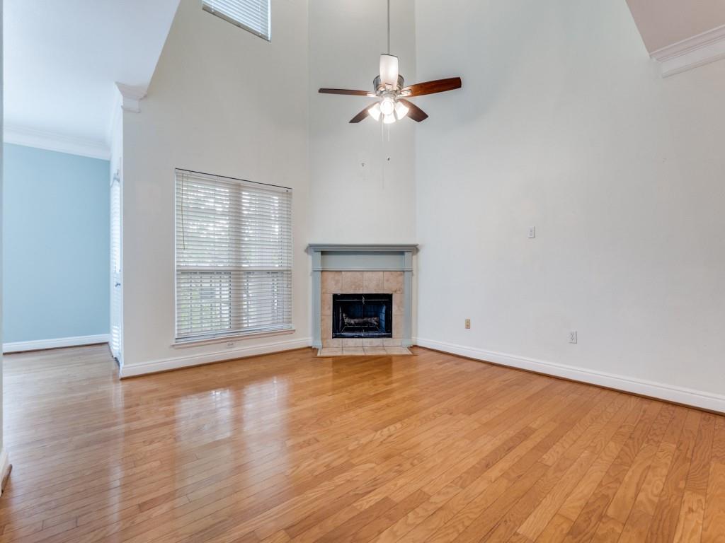 5407 Bryan Street, Unit B209 Dallas, TX 75206 - Photo 3 of 25 a view of an empty room with wooden floor fireplace and a window