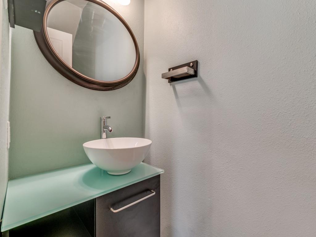 5407 Bryan Street, Unit B209 Dallas, TX 75206 - Photo 6 of 25 a bathroom with a sink a toilet and a mirror