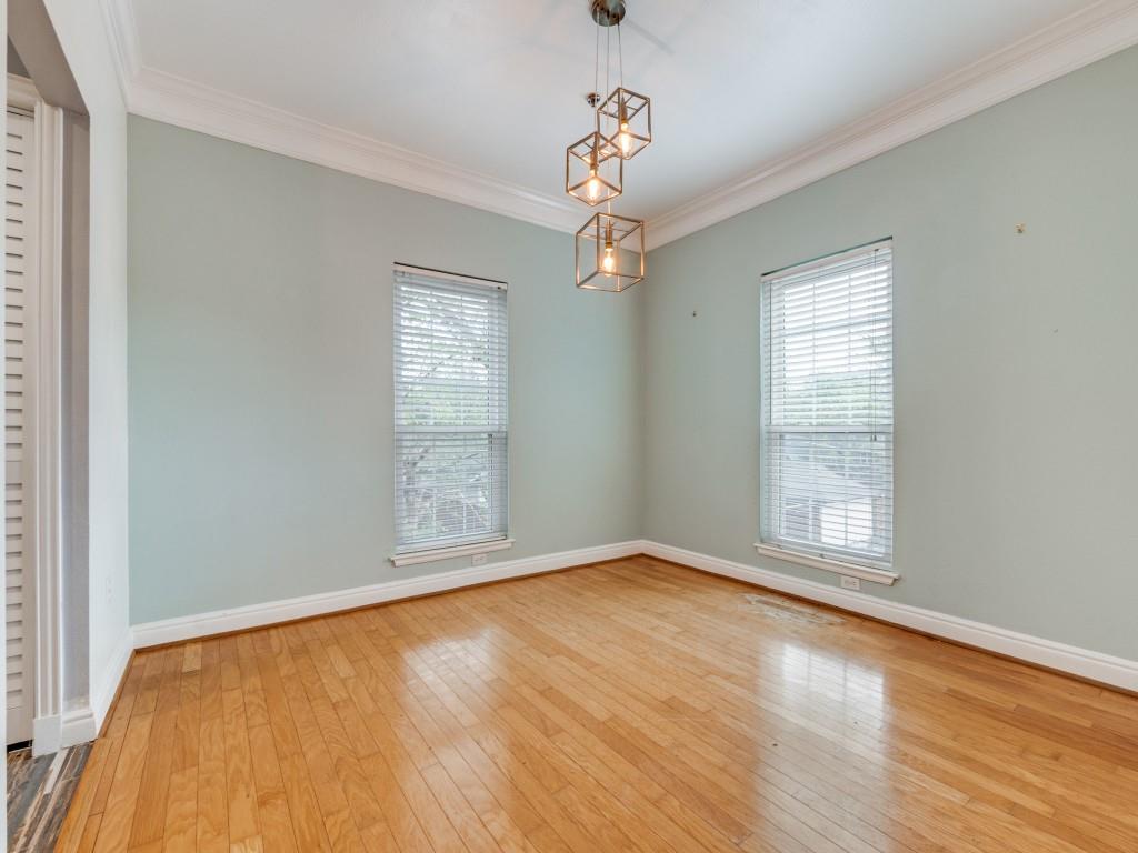 5407 Bryan Street, Unit B209 Dallas, TX 75206 - Photo 8 of 25 a view of an empty room with wooden floor and a window