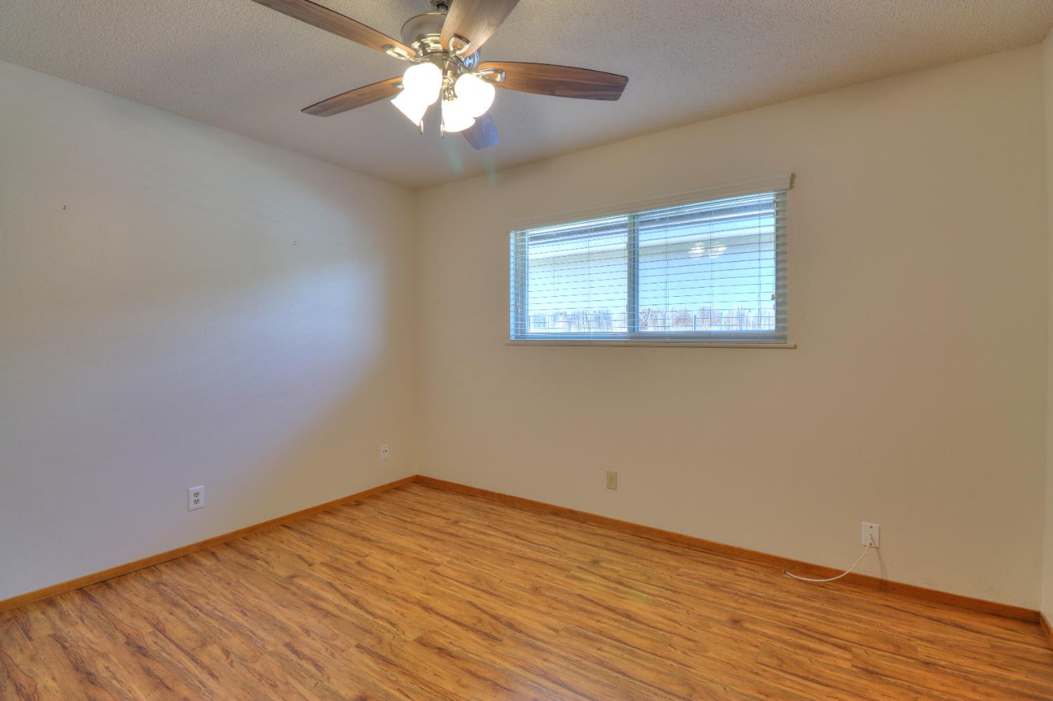 6265 North Colonial Avenue Fresno, CA 93704 - Photo 13 of 22 a view of empty room with wooden floor and fan