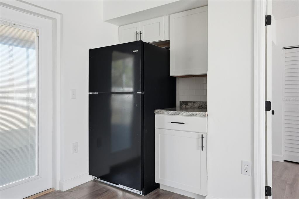 2076 Landover Boulevard Spring Hill, FL 34608 - Photo 17 of 37 a kitchen with a refrigerator and cabinets
