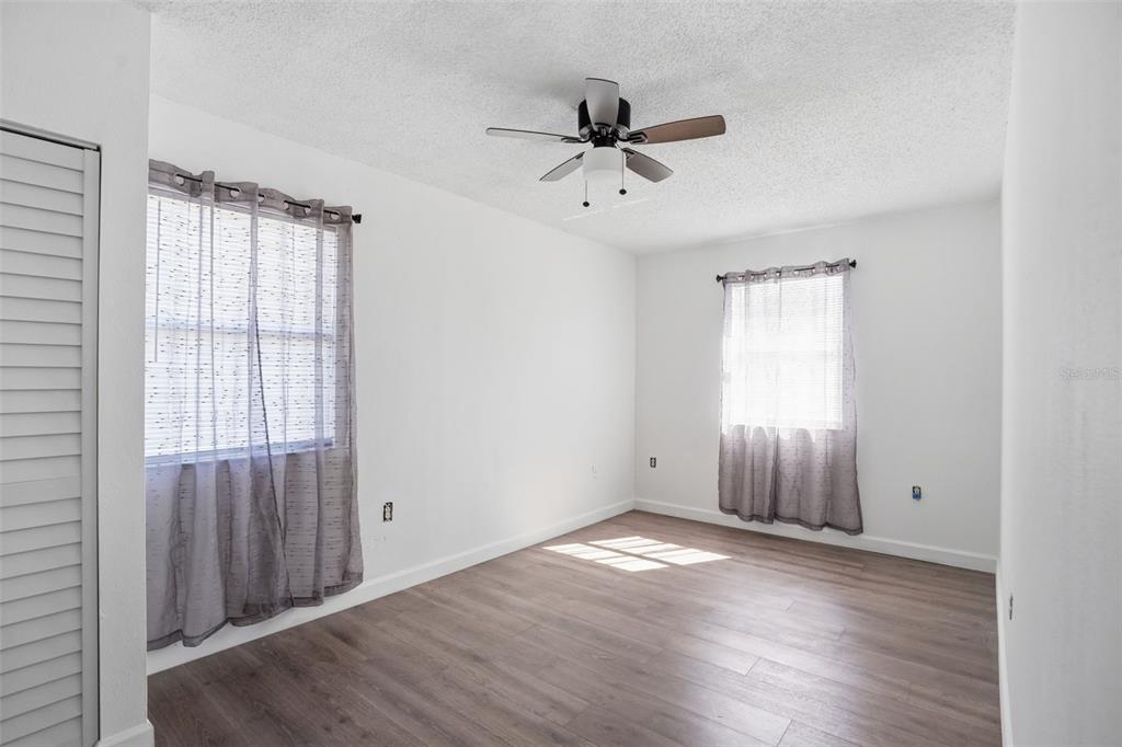 2076 Landover Boulevard Spring Hill, FL 34608 - Photo 19 of 37 wooden floor in an empty room with a window