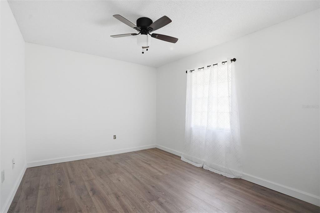 2076 Landover Boulevard Spring Hill, FL 34608 - Photo 23 of 37 an empty room with a window and a fan