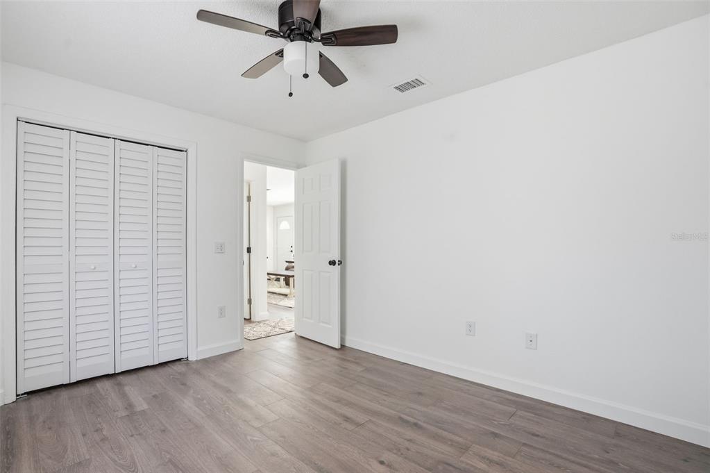 2076 Landover Boulevard Spring Hill, FL 34608 - Photo 25 of 37 an empty room with wooden floor closet and windows
