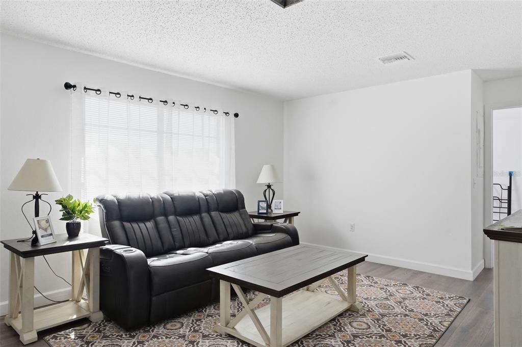 2076 Landover Boulevard Spring Hill, FL 34608 - Photo 6 of 37 a living room with furniture and a rug