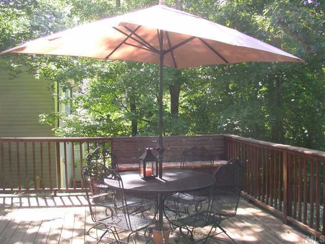 5120 Celbridge Place Raleigh, NC 27613 - Photo 11 of 12 a view of a patio with table and chairs under an umbrella