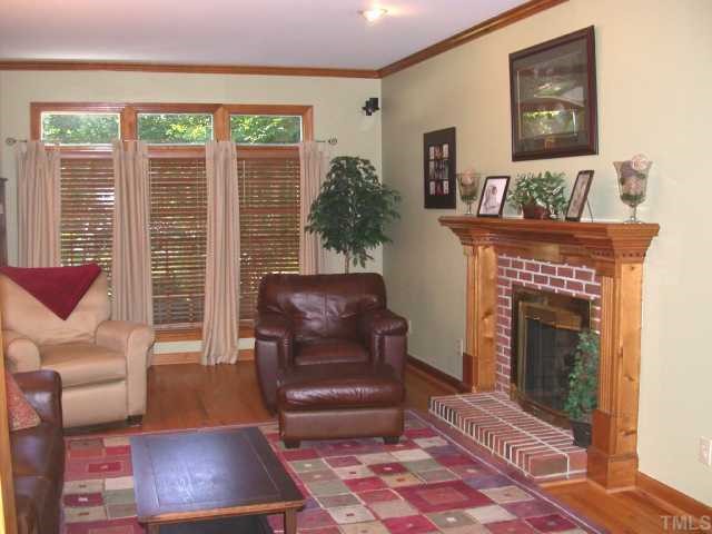 5120 Celbridge Place Raleigh, NC 27613 - Photo 5 of 12 a living room with furniture and a fireplace