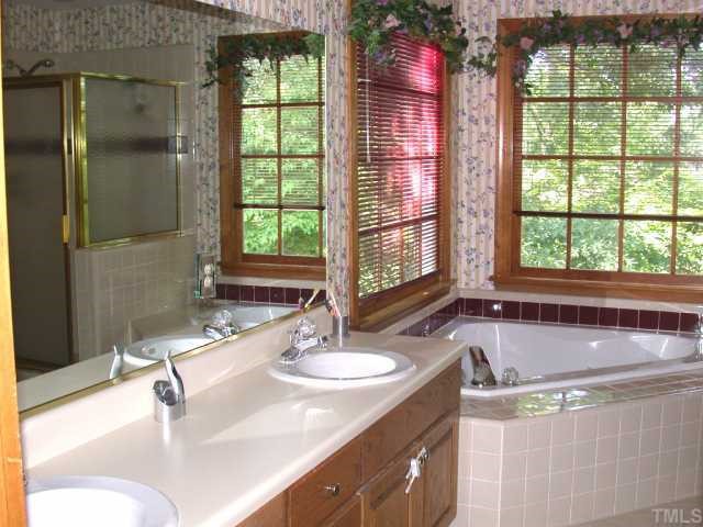 5120 Celbridge Place Raleigh, NC 27613 - Photo 8 of 12 a bathroom with a granite countertop sink and a bathtub