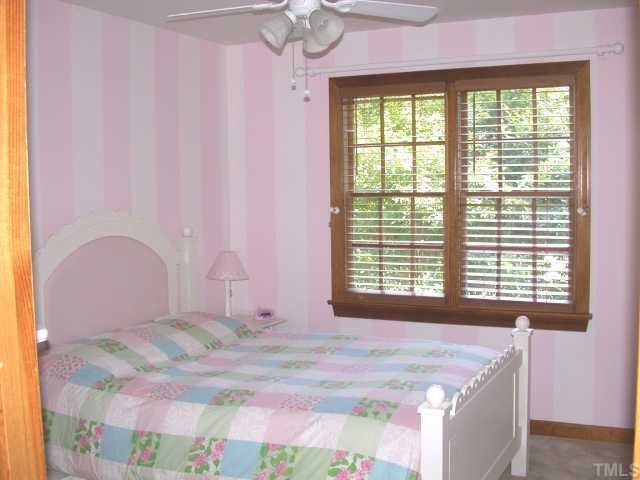 5120 Celbridge Place Raleigh, NC 27613 - Photo 9 of 12 a bedroom with a bed and a window