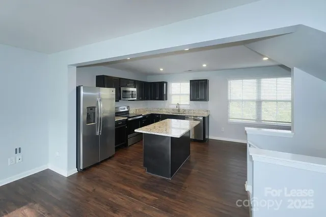 a kitchen with a sink and steel stainless steel appliances