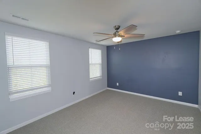 a view of room with a ceiling fan and window