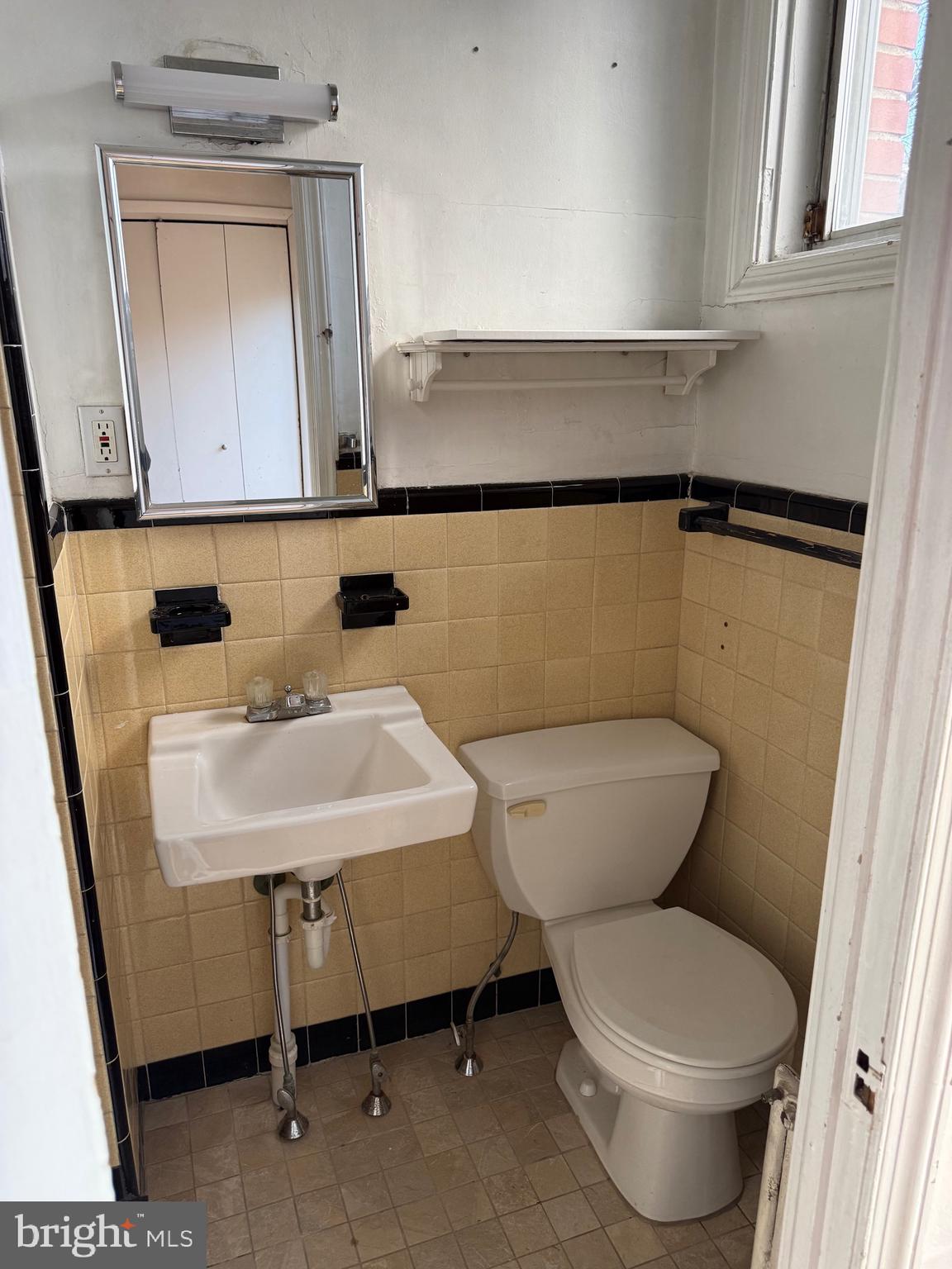 1720 Spruce Street, Unit 5 Philadelphia, PA 19103 - Photo 4 of 24 a bathroom with a sink a toilet and mirror