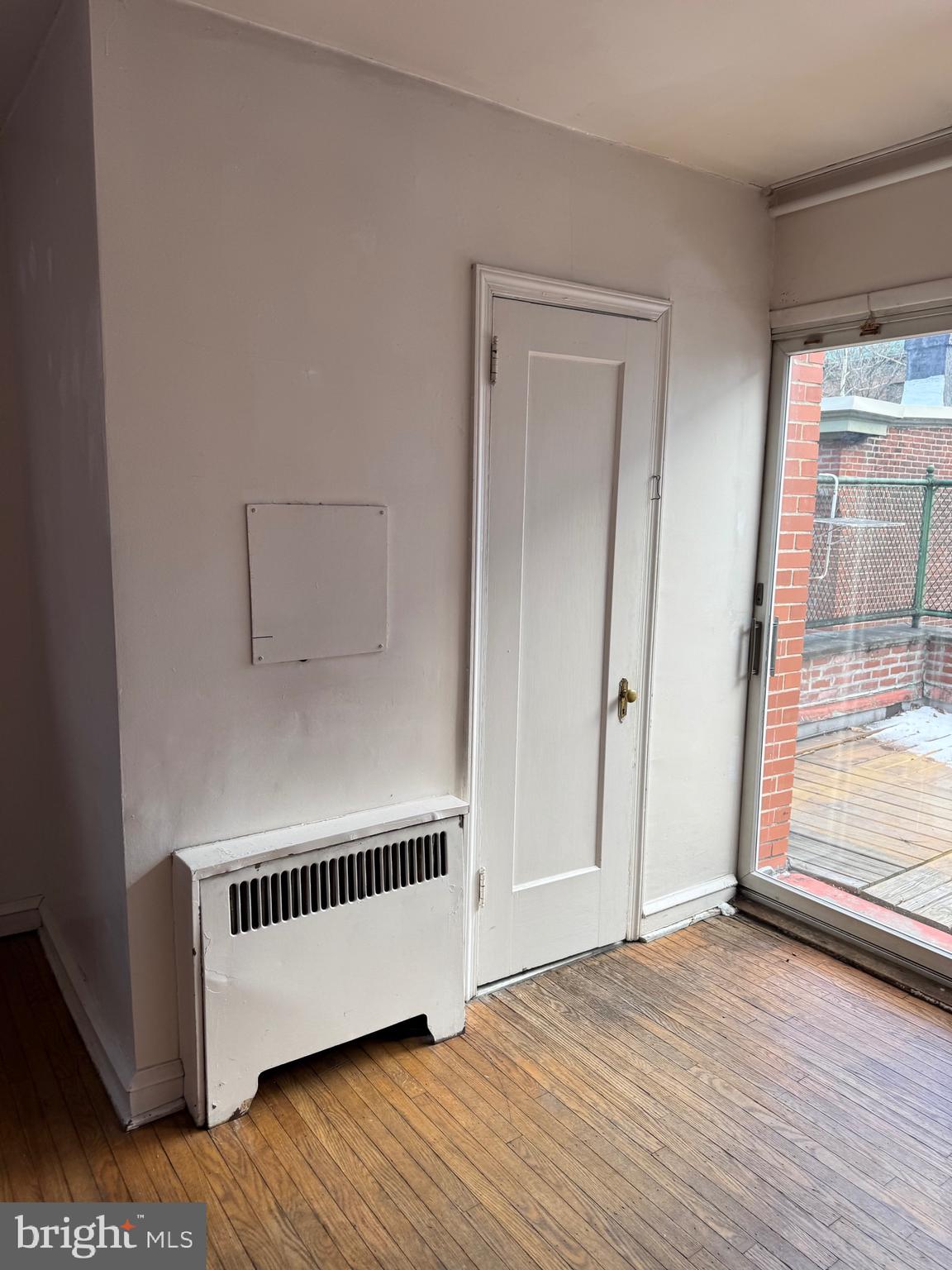 1720 Spruce Street, Unit 5 Philadelphia, PA 19103 - Photo 5 of 24 a view of an empty room with wooden floor and a window