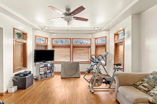 a living room with furniture and a flat screen tv with wooden floor