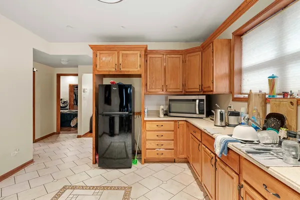 a kitchen with stainless steel appliances kitchen island granite countertop a refrigerator and a stove top oven