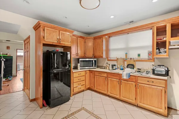 a kitchen with sink refrigerator and cabinets