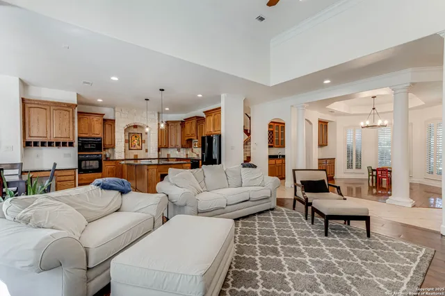 a living room with furniture and view of kitchen