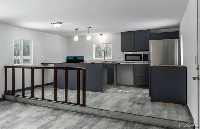 a kitchen with stainless steel appliances granite countertop a refrigerator and a stove