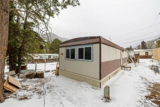 a view of a house with a snow in the yard