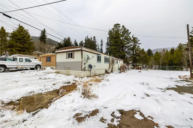 a view of a house with snow on the road